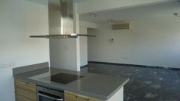 Modern design of the kitchen with the cooker, oven and extractor fan, living room area and air conditions