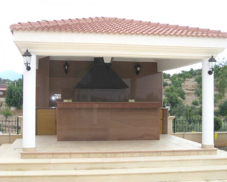 This is the outdoor covered barbeque area which also includes a counter that could be used as a bar.