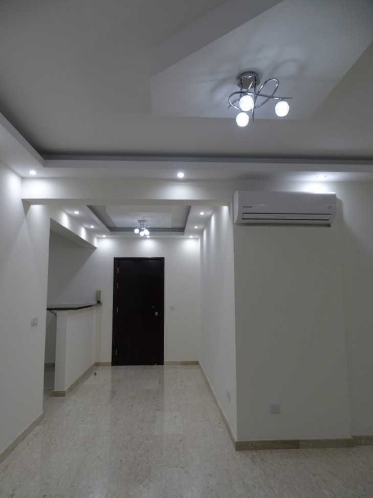 Picture of the entry hall of the apartment having the kitchen on the left and the living room on the front.