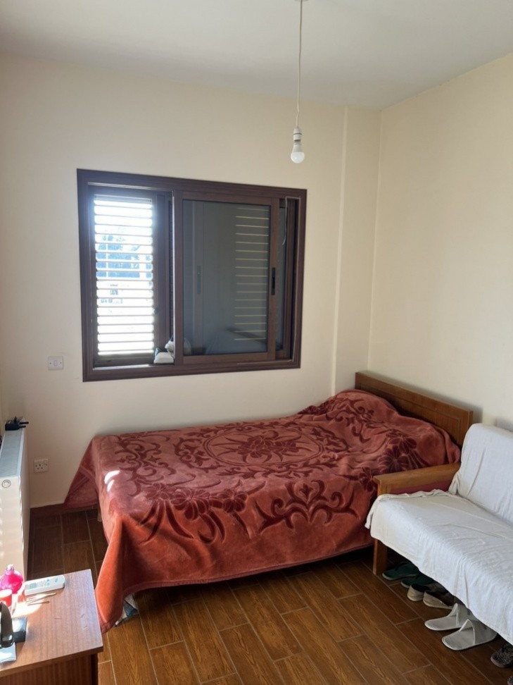 Picture of the third of the bedrooms, having double-glazed windows, an air-conditioning unit, and a double-size bed.