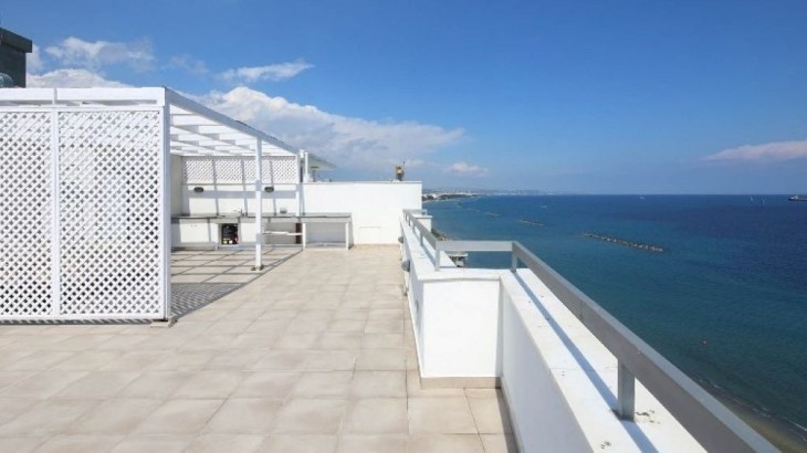 Roof-garden-area with sea view, marble glazed floor tiles, and semi-covered sitting area