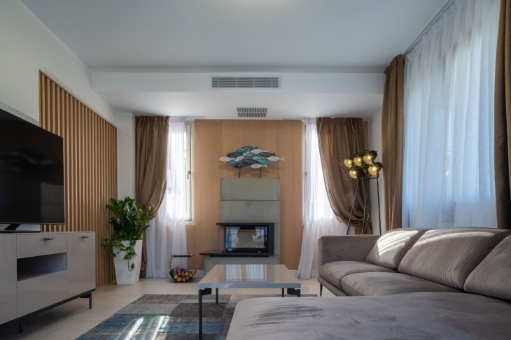 Picture of the living room area of the detached villa, fully furnished and equipped with a TV.