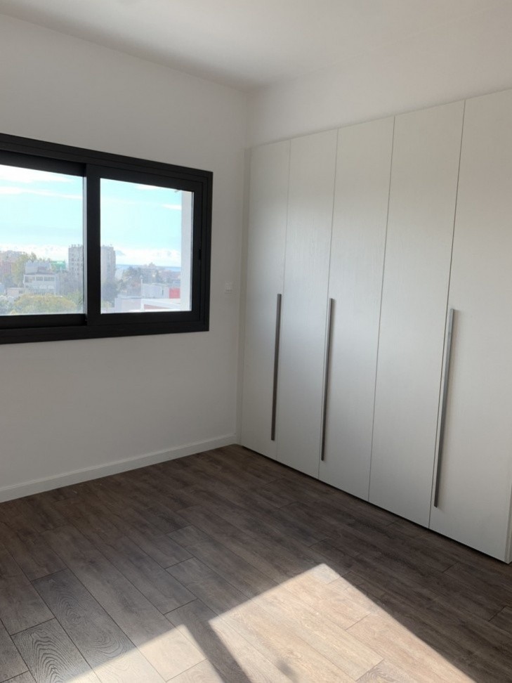 Spacious bedroom area with wardrobes, double glazed windows and laminated flooring