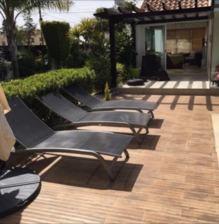 Picture of the sunloungers by the swimming pool.