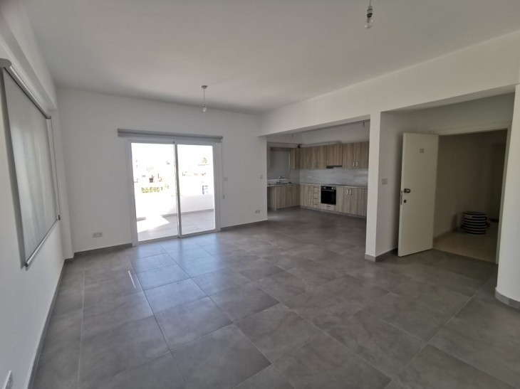 Spacious open plan kitchen, dining, and living room area, with access to a beautiful balcony