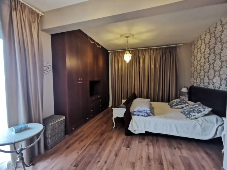 Spacious main bedroom with a double bed and wardrobe
