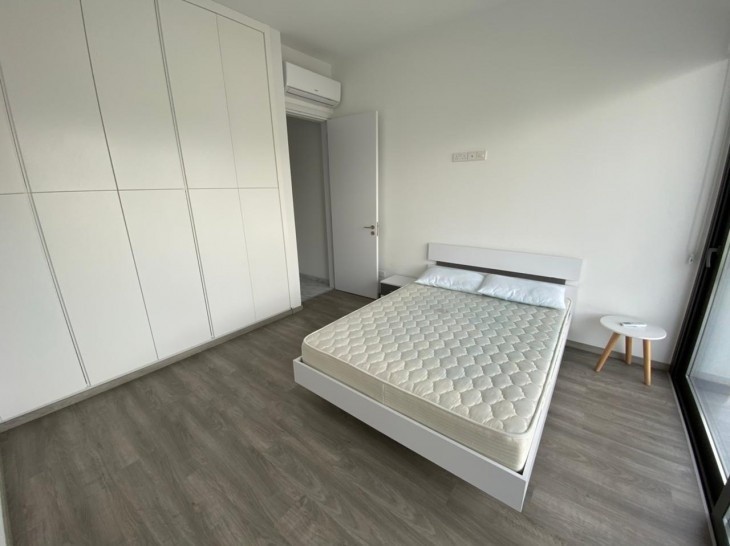 Image of the first bedroom with one double bed, bedside tables, a/c, large cupboards