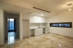 Picture of the open layout dining, kitchen, and living room areas, with luxurious marble flooring and embedded air-conditioning.